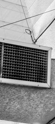A ceiling air duct vent grille in black and white